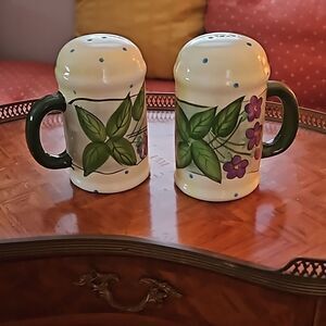 Vintage ceramic salt and pepper shakers with green and blue flowers.